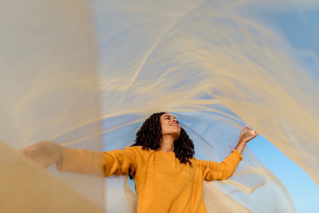 freedom-concept-with-woman-holding-cloth-nature-scaled