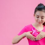 breast-cancer-awareness-woman-pink-t-shirt-with-satin-pink-ribbon-her-chest-supporting-symbolbreast-cancer-awareness.
